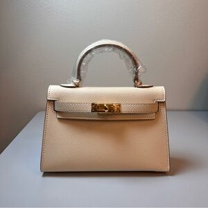 Genuine Epsom Leather mini handbag with shoulder strap featuring Gold hardware